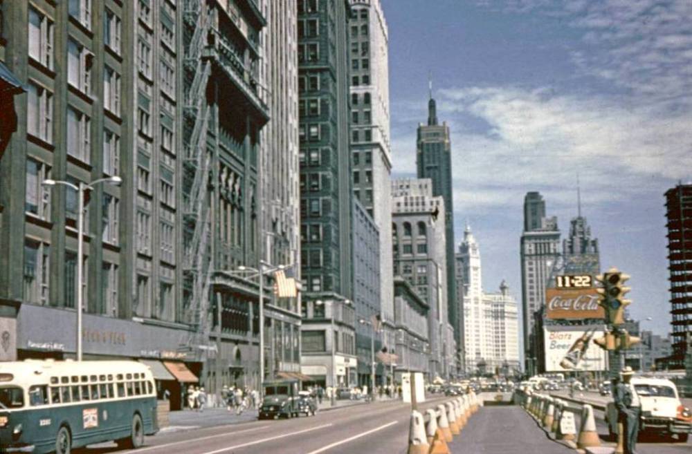 A PHOTO - CHICAGO - MICHIGAN AVE - LOOKING N GROUND LEVEL - NOTE BUS ON LEFT - OLD ENTRANCE OR EXIT FOR GARAGE - ON RIGHT PRUDENTIAL BUILDING UNDER CONSTRUCTION - COMPLETED 1955