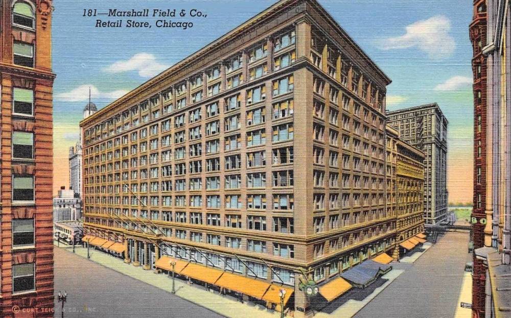 A POSTCARD - MARSHALL FIELD'S - STATE AND WASHINGTON - AERIAL THREE-QUARTER VIEW - TINTED - NOTE ON RIGHT BIT OF COLUMBUS BUILDING TORN DOWN IN 1959