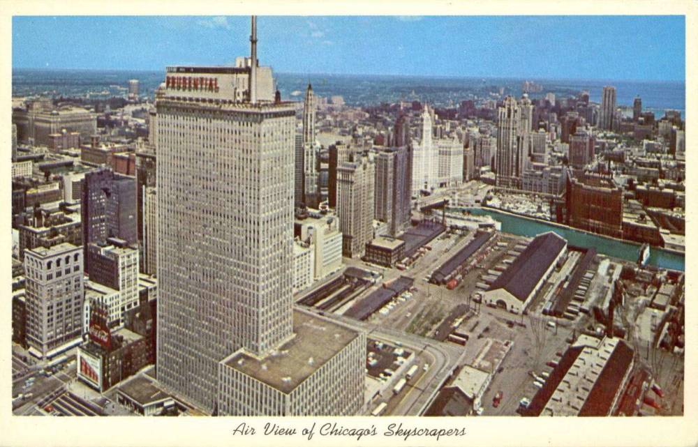 A POSTCARD - CHICAGO - PRUDENTIAL BUILDING AND SURROUNDINGS - AERIAL - VIEW OF ILLINOIS CENTRAL YARDS - PANORAMA LOOKING NE - c1960